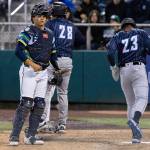 Luke Stevenson (32) of the Everett AquaSox looks on as Anthony Scull (23) of the Tri-City Dust Devils scores the 15th run during the fourth inning on Tuesday, April 7, 2026 in Everett, Washington. (Olivia Vanni / The Herald)