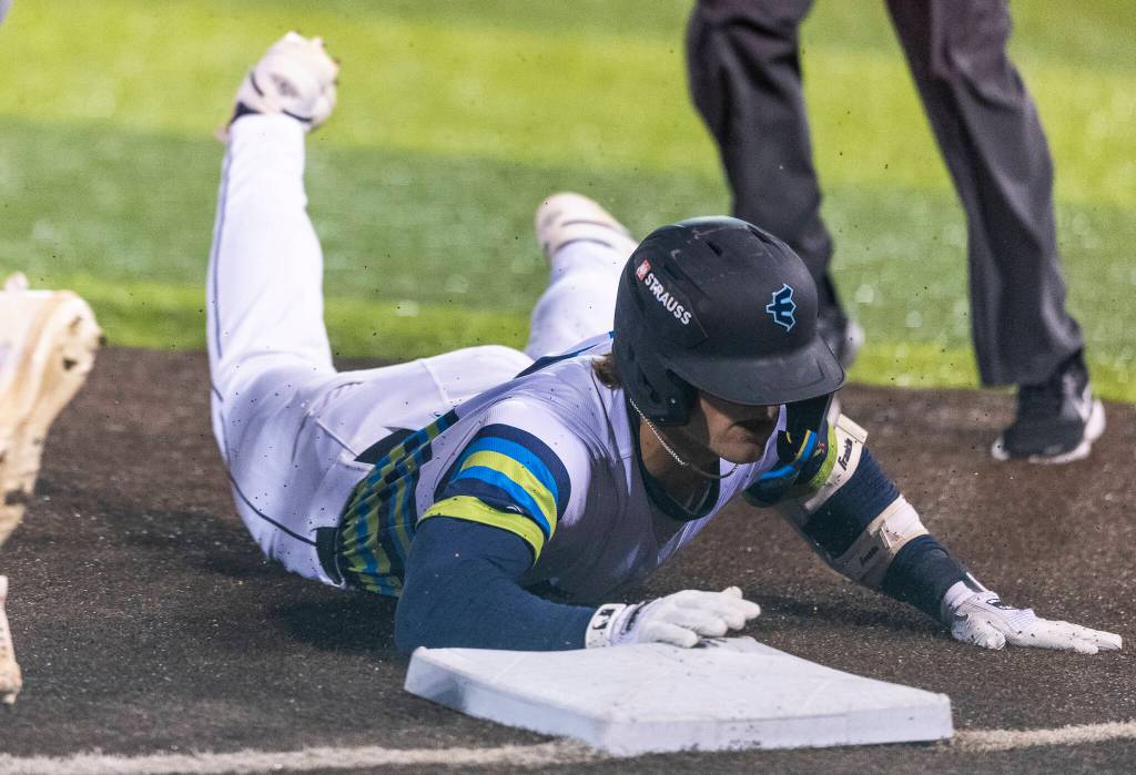 Josh Caron (10) of the Everett AquaSox safely slides into third base for a triple during the game against the Tri-City Dust Devils on Tuesday, April 7, 2026 in Everett, Washington. (Olivia Vanni / The Herald)