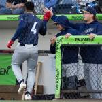 Capri Ortiz (4) of the Tri-City Dust Devils high fives his teammates after scoring during the game against the Everett AquaSox on Tuesday, April 7, 2026 in Everett, Washington. (Olivia Vanni / The Herald)