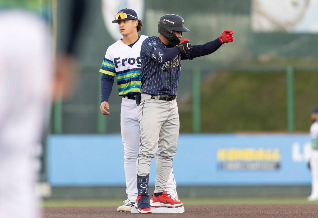 A Tri-City Dust Devils player motions to his dugout on Tuesday, April 7, 2026 in Everett, Washington. (Olivia Vanni / The Herald)