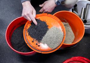 President and Chief Technology Officer of EcoRemedy David Mooney shows two different products they are able to create from the gasification process at the Edmonds Wastewater Treatment Plant in April 2025 in Edmonds. (Olivia Vanni / The Herald)