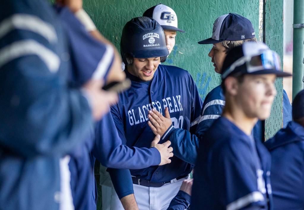 Glacier Peaks Emmett Brown is high-fived by his teammates after scoring during the game against Meadowdale on Wednesday, April 8, 2026 in Lynnwood, Washington. (Olivia Vanni / The Herald)