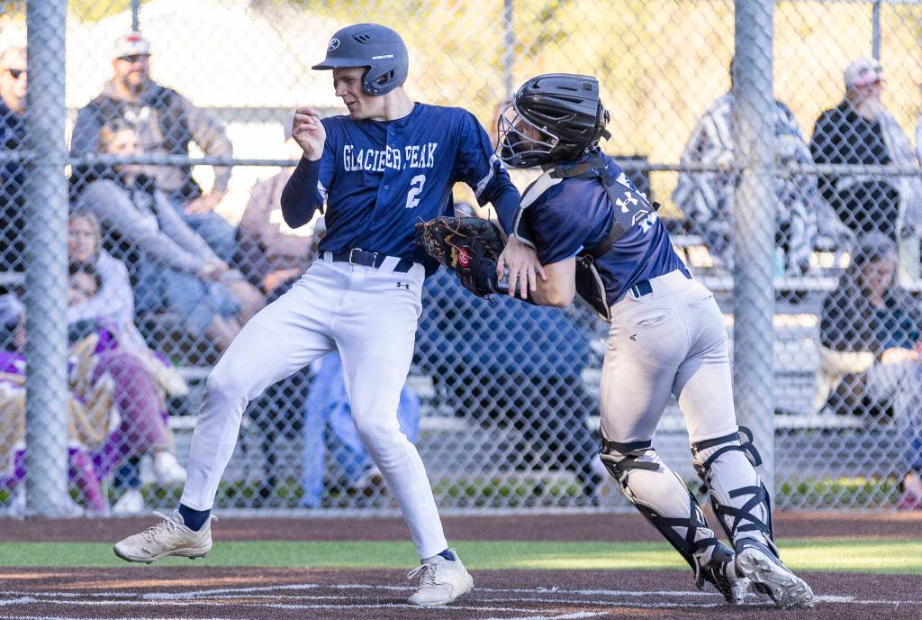 Glacier Peaks Brody Monica is tagged out at home by Meadowdales Benjamin Webster during the game on Wednesday, April 8, 2026 in Lynnwood, Washington. (Olivia Vanni / The Herald)