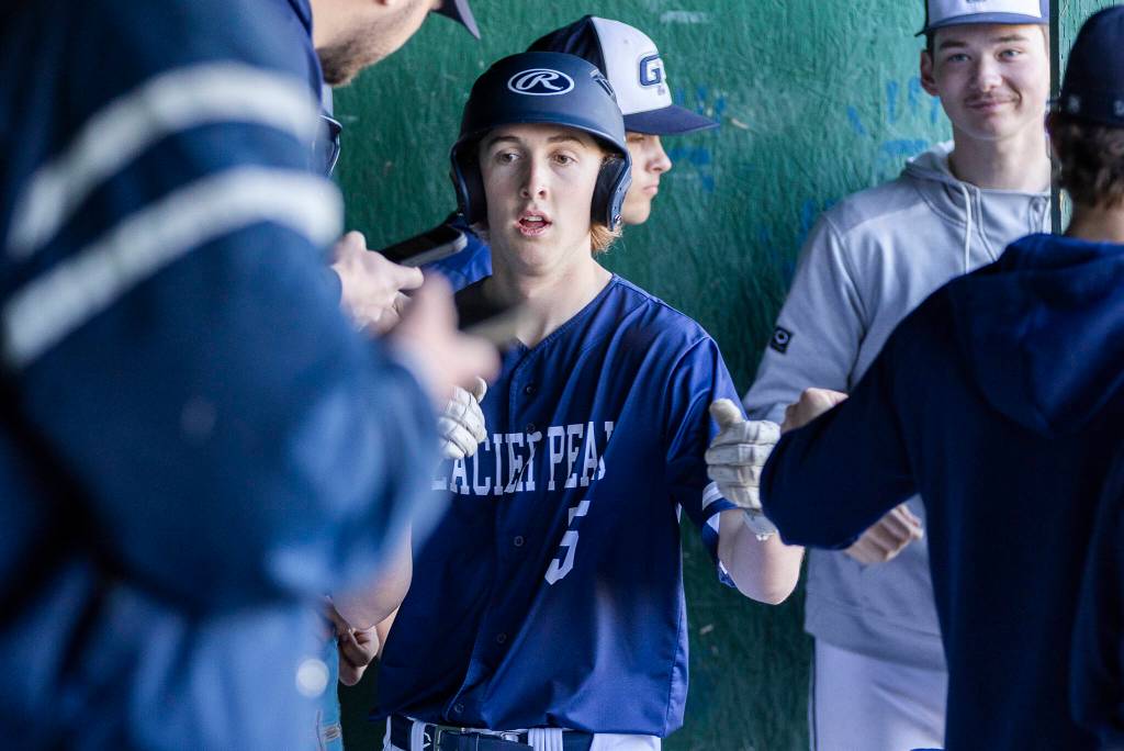 Glacier Peaks William Dacy is high-fived by his teammates after scoring during the game against Meadowdale on Wednesday, April 8, 2026 in Lynnwood, Washington. (Olivia Vanni / The Herald)