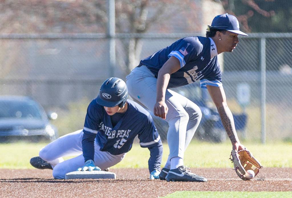 Glacier Peaks Lucas Keller slides safely into second base past Meadowdales Kealoha Kepoo-Sabate during the game against Meadowdale on Wednesday, April 8, 2026 in Lynnwood, Washington. (Olivia Vanni / The Herald)