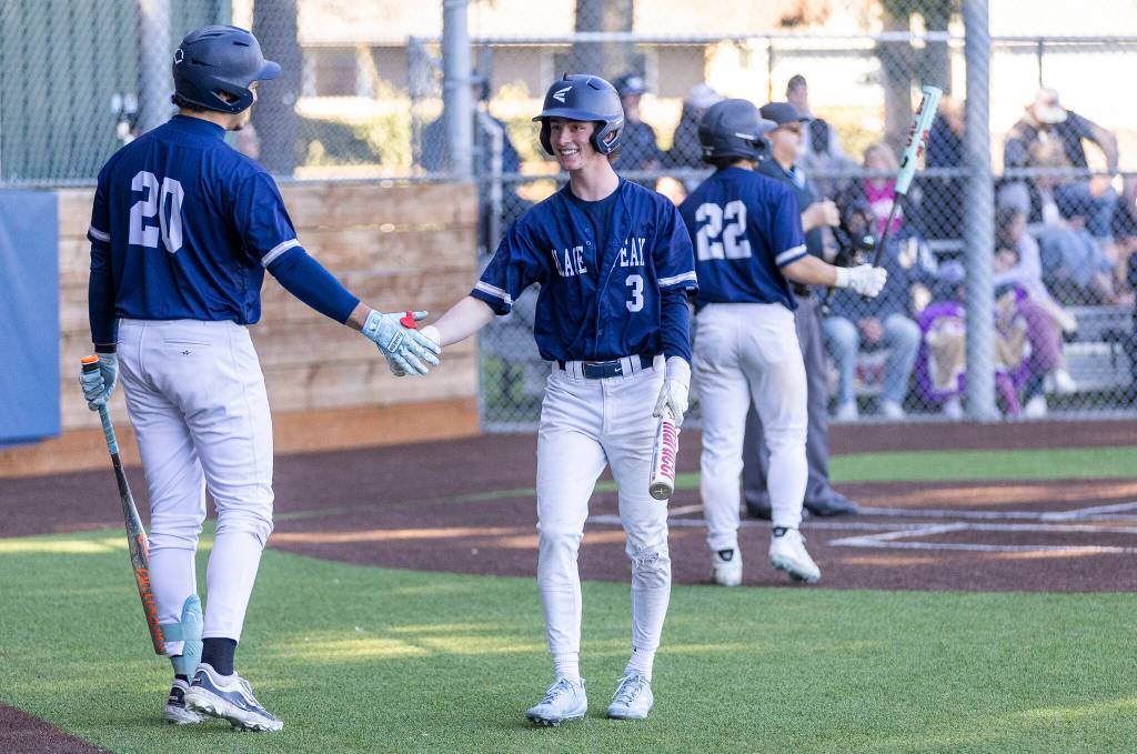 Glacier Peaks Matthew Marquardt high-fives Glacier Peaks Emmett Brown after scoring during the game against Meadowdale on Wednesday, April 8, 2026 in Lynnwood, Washington. (Olivia Vanni / The Herald)