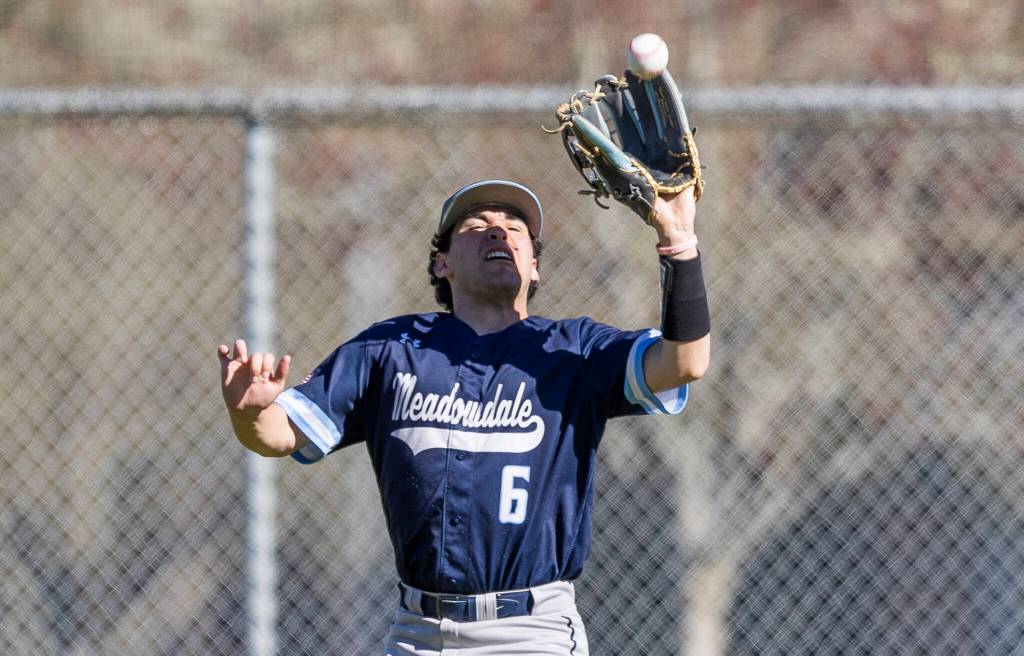 Meadowdales Keegan Wright makes a catch in the outfield during the game against Glacier Peak on Wednesday, April 8, 2026 in Lynnwood, Washington. (Olivia Vanni / The Herald)