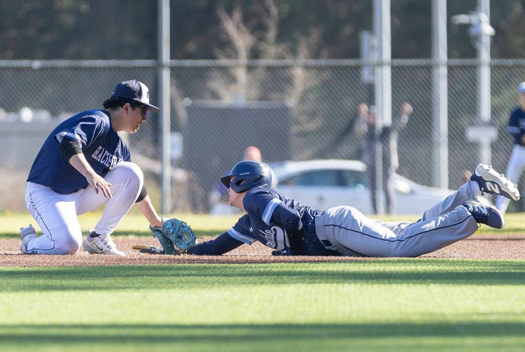 Glacier Peaks Aiden Yoo tags out Meadowdales Benjamin Webster as he slides into second base during the game on Wednesday, April 8, 2026 in Lynnwood, Washington. (Olivia Vanni / The Herald)