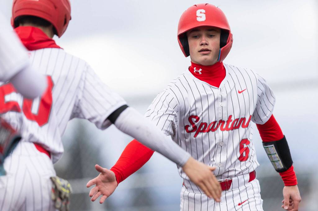 Stanwoods Grady Lamb high-fives a teammate after scoring during the game against Mountlake Terrace on Wednesday, April 15, 2026 in Stanwood, Washington. (Olivia Vanni / The Herald)