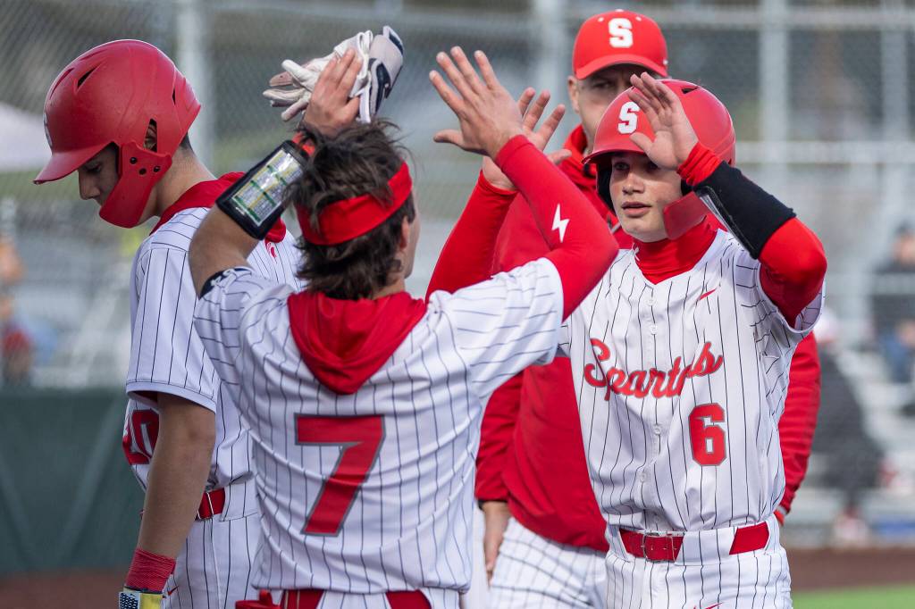 Stanwoods Grady Lamb high-fives Corban Forslund after scoring during the game against Mountlake Terrace on Wednesday, April 15, 2026 in Stanwood, Washington. (Olivia Vanni / The Herald)