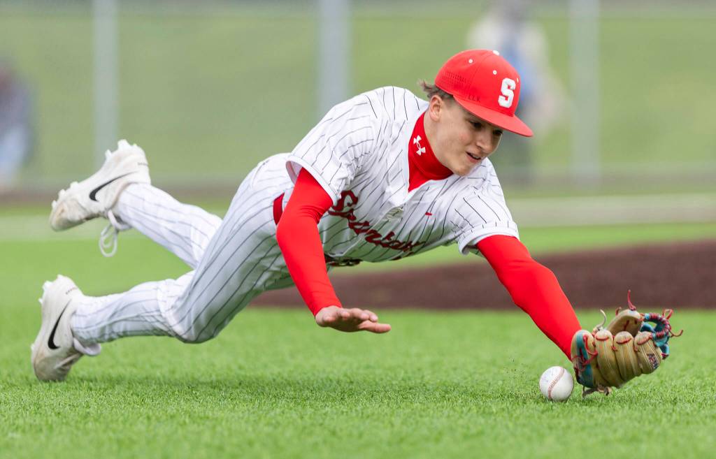 Stanwoods Braddock Johnson dives for the ball to try and make a catch during the game against Mountlake Terrace on Wednesday, April 15, 2026 in Stanwood, Washington. (Olivia Vanni / The Herald)