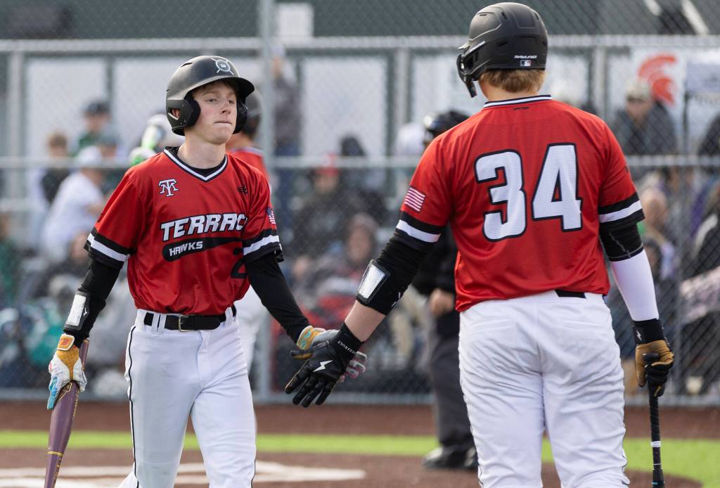 Mountlake Terraces Will VanDeMark high-fives after scoring during the game against Stanwood on Wednesday, April 15, 2026 in Stanwood, Washington. (Olivia Vanni / The Herald)