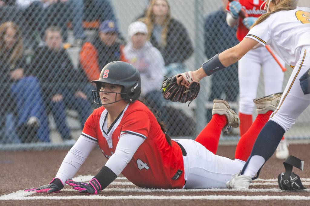 Snohomishs Taylor Ward slides into home plate to score during the game against Everett on Thursday, April 16, 2026 in Everett, Washington. (Olivia Vanni / The Herald)