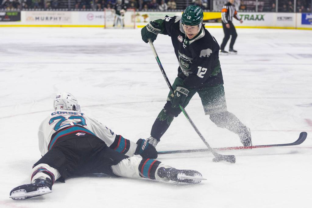 Lukas Kaplan #12 of the Everett Silvertips shoots the puck past Nate Corbet #22 of the Kelowna Rockets during Game 5 of the Western Hockey League second round on Friday, April 17, 2026 in Everett, Washington. (Olivia Vanni / The Herald)