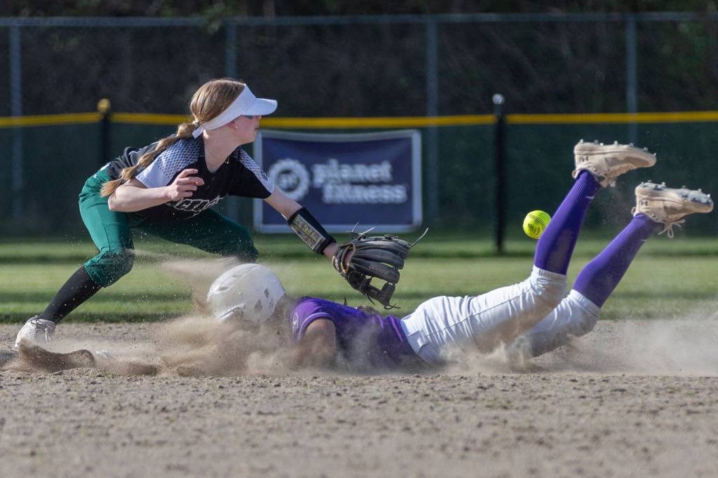 Kamiaks Synclair Mawudeku slides safely into second base past Jacksons Nicole Burnett during the game against Jackson on Monday, April 20, 2026 in Mill Creek, Washington. (Olivia Vanni / The Herald)