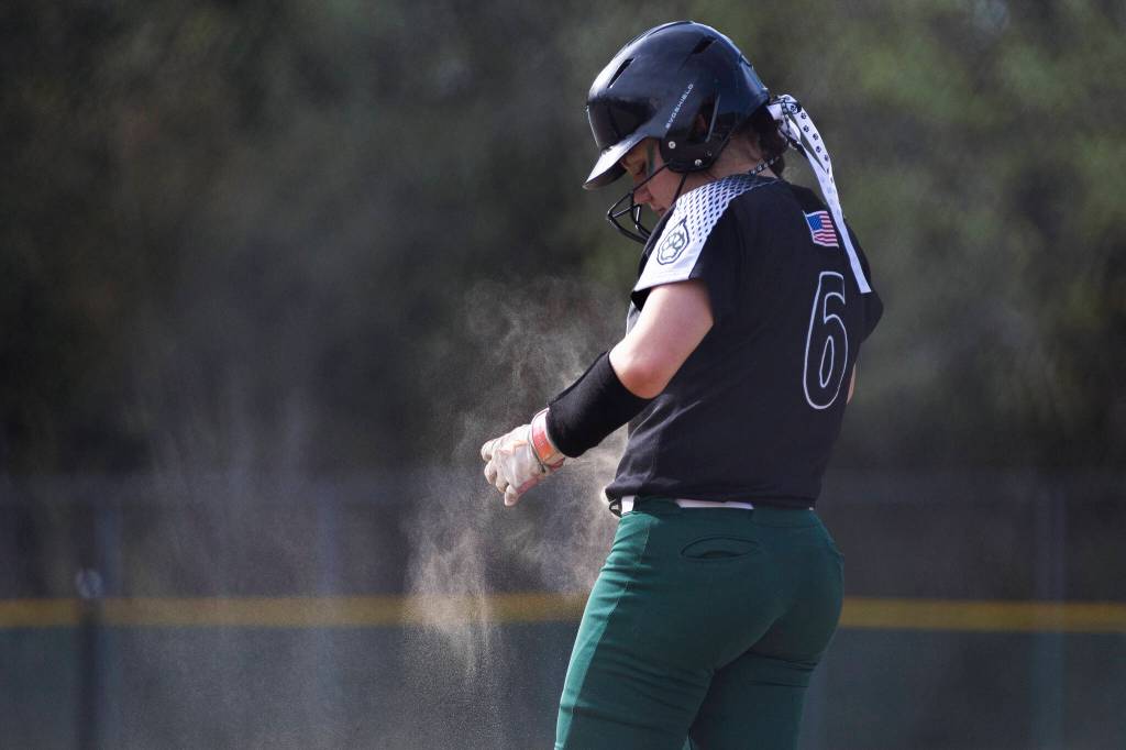 Jacksons Coralynn Augustine brushes dirt off of her jersey during the game against Kamiak on Monday, April 20, 2026 in Mill Creek, Washington. (Olivia Vanni / The Herald)
