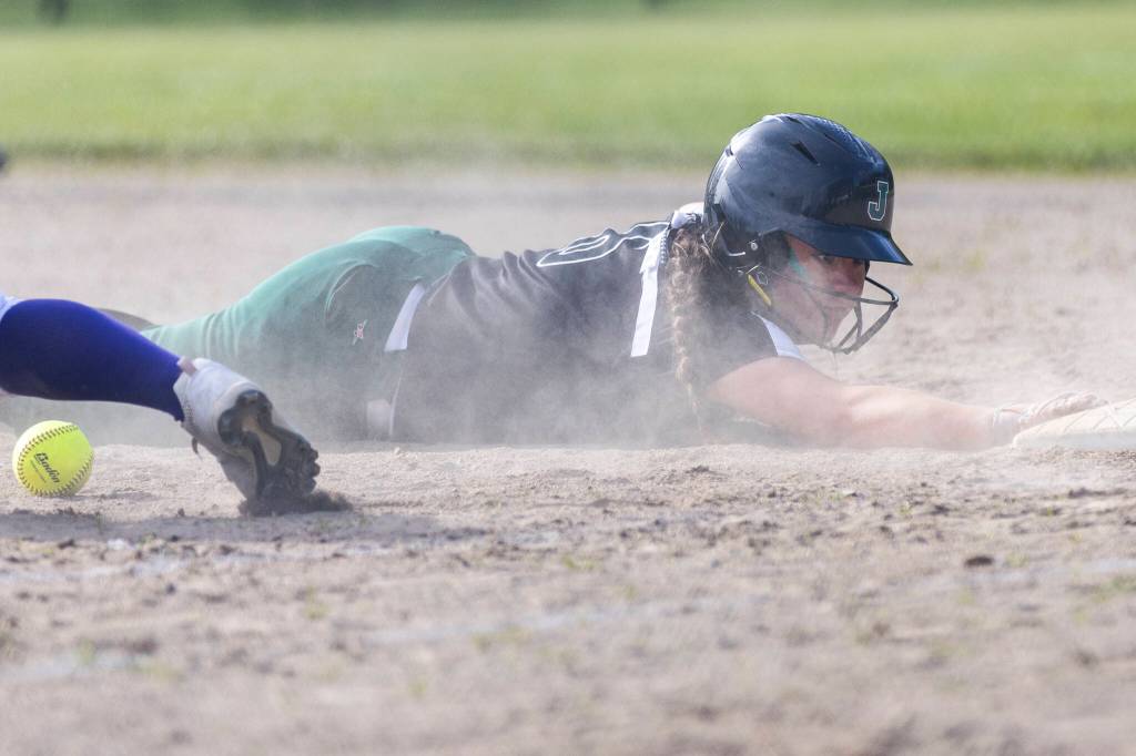 Jacksons Coralynn Augustine safely dives back to first base during the game against Kamiak on Monday, April 20, 2026 in Mill Creek, Washington. (Olivia Vanni / The Herald)