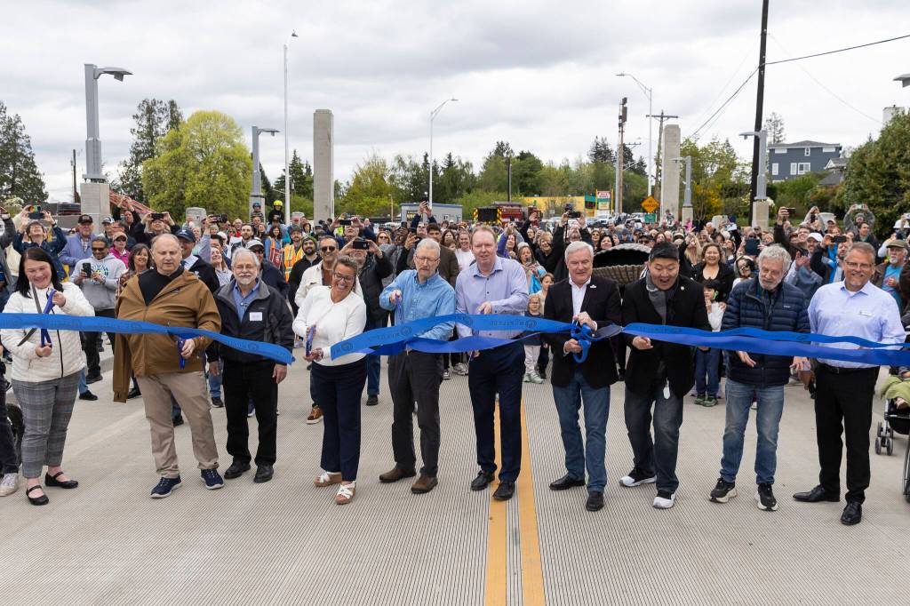 Everett Mayor Cassie Franklin and Mukilteo Mayor Joe Marine, along with council members and community members from both cities, cut the ribbon for the new Edgewater Bridge on Monday, April 27, 2026, in Everett, Washington. (Olivia Vanni / The Herald)