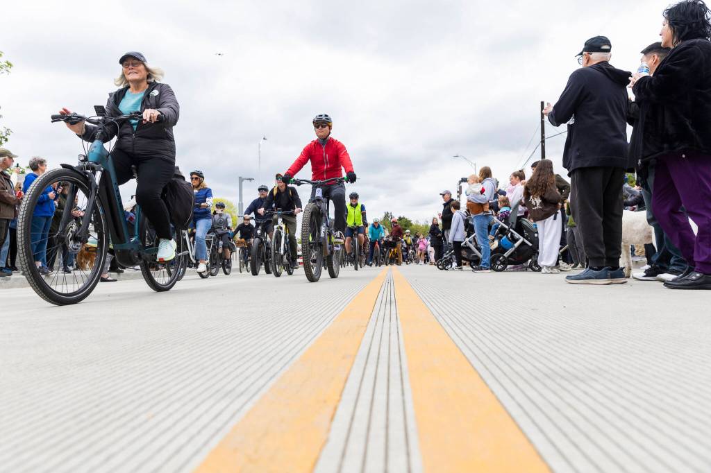 Cyclists ride their bikes across the reopened Edgewater Bridge on Monday, April 27, 2026, in Everett, Washington. (Olivia Vanni / The Herald)