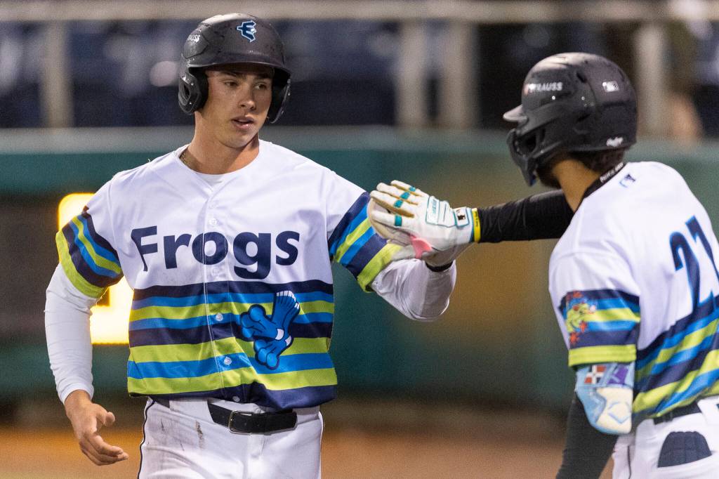 Jonny Farmelo #15 of the Everett AquaSox high-fives Axel Sanchez #21 of the Everett AquaSox after during the sixth inning against the Spokane Indians on Tuesday, April 21, 2026 in Everett, Washington. (Olivia Vanni / The Herald)