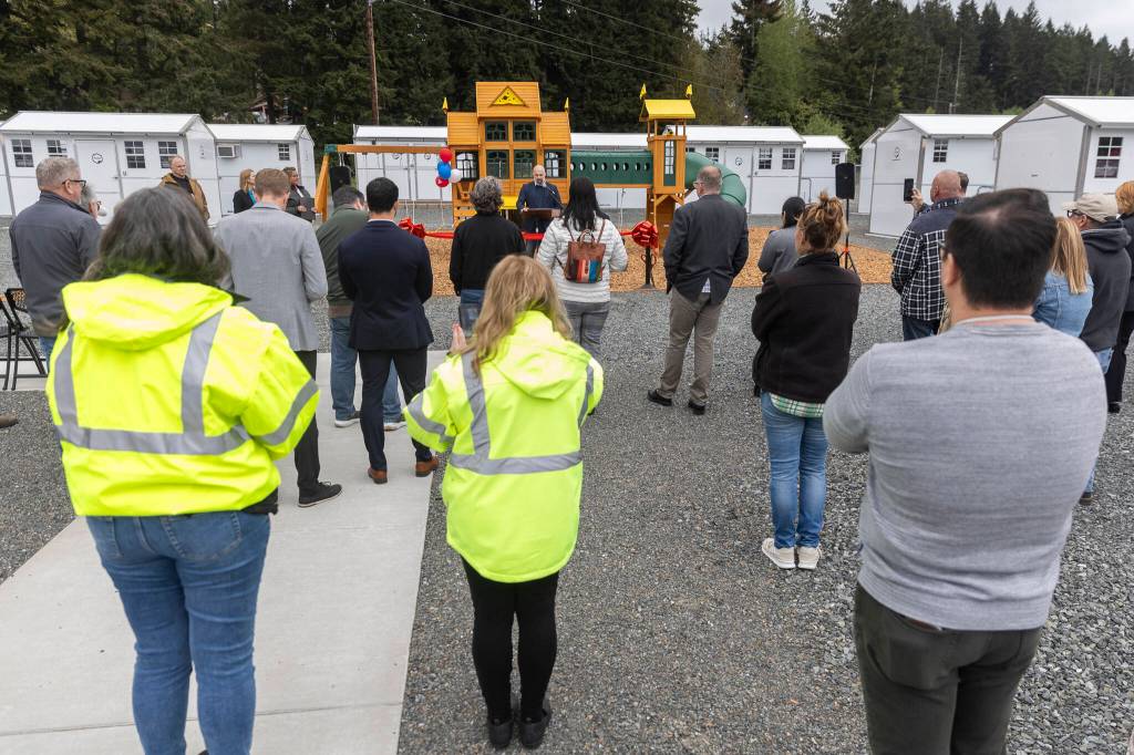 People gather for a ribbon cutting for the new Pallet shelter opening on Monday, April 27, 2026, in Everett, Washington. (Olivia Vanni / The Herald)