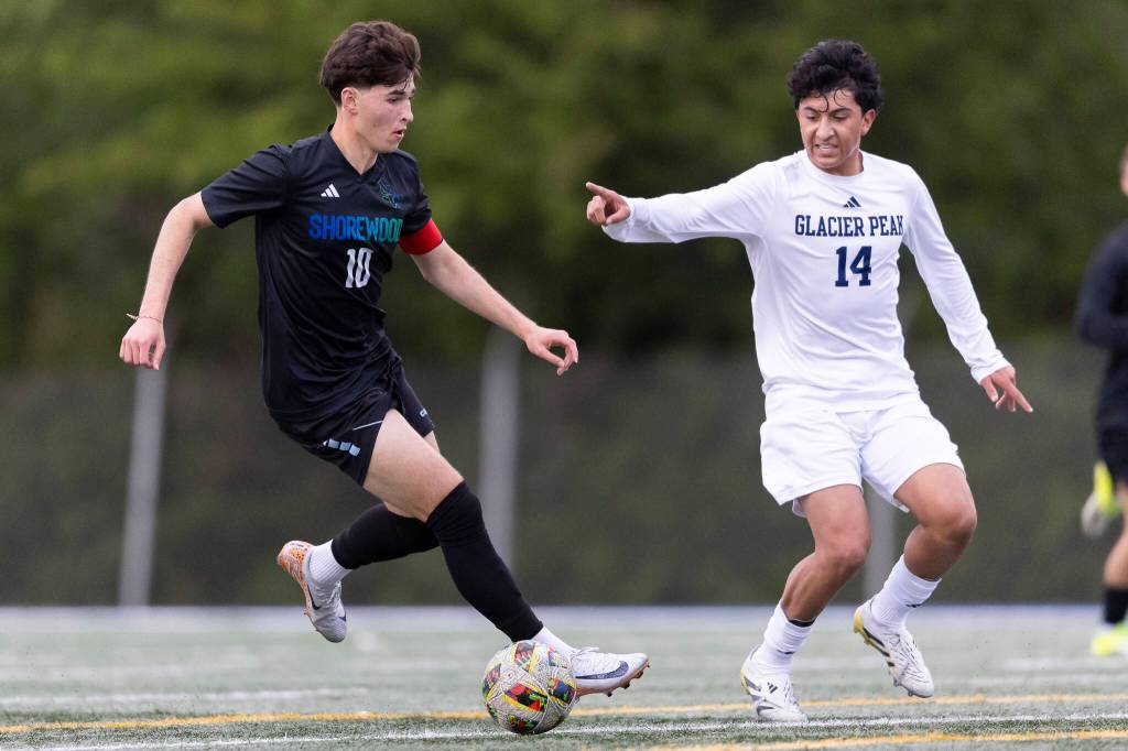 Shorewoods Nikola Genadiev dribbles the ball up the field while under pressure from Glacier Peaks Josiah Calderon during the game on Tuesday, April 28, 2026 in Shoreline, Washington. (Olivia Vanni / The Herald)