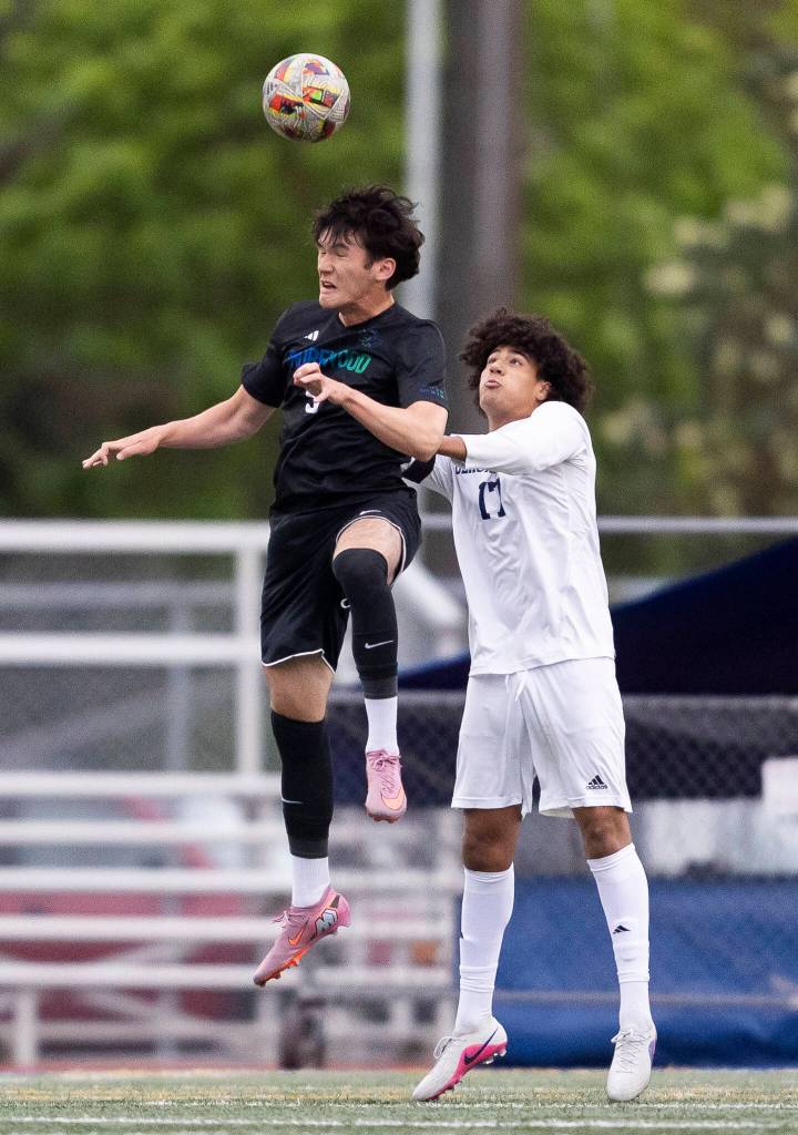 Shorewoods Kaito Ayers heads the ball against Glacier Peaks Joziah Coppin during the game on Tuesday, April 28, 2026 in Shoreline, Washington. (Olivia Vanni / The Herald)