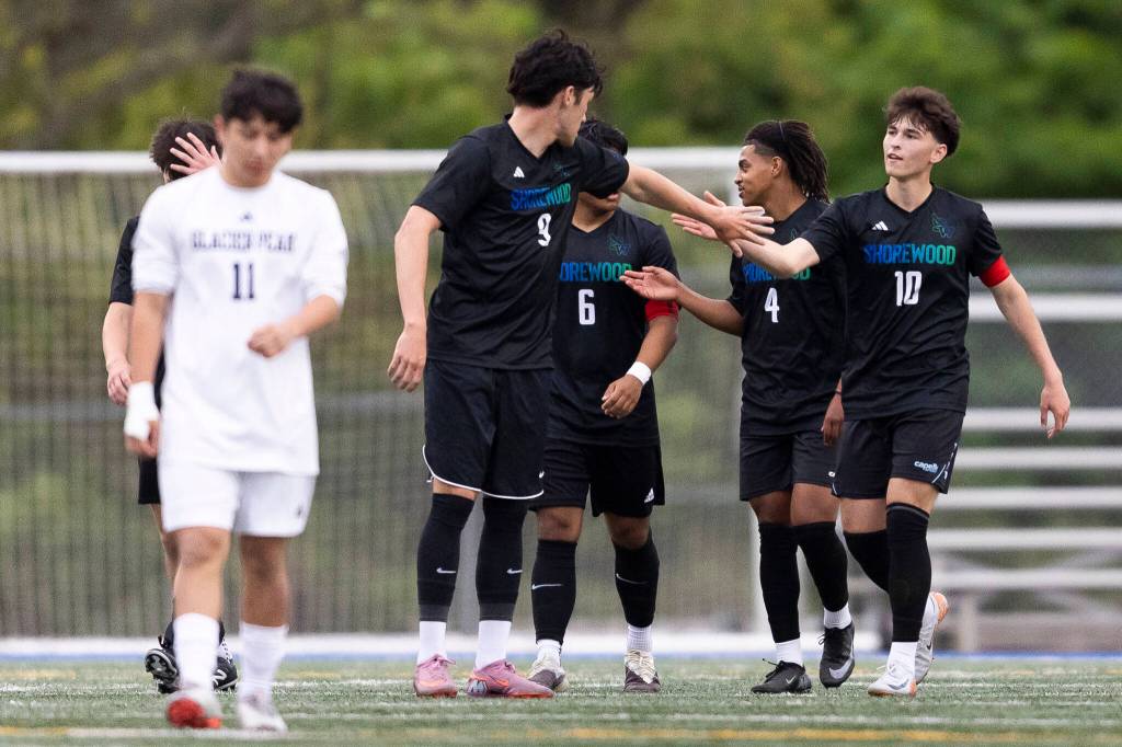 Shorewoods Kaito Ayers high-fives Shorewoods Nikola Genadiev after his goal during the game against Glacier Peak on Tuesday, April 28, 2026 in Shoreline, Washington. (Olivia Vanni / The Herald)