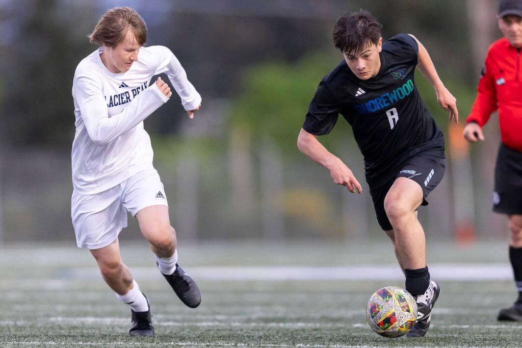Shorewoods Elias Magallanes dribbles the ball up the field while under pressure from Glacier Peaks Kai Jewett during the game on Tuesday, April 28, 2026 in Shoreline, Washington. (Olivia Vanni / The Herald)