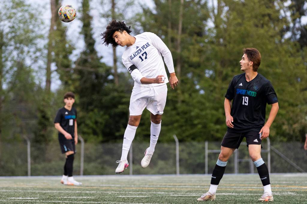 Glacier Peaks Joziah Coppin heads the ball during the game against Shorewood on Tuesday, April 28, 2026 in Shoreline, Washington. (Olivia Vanni / The Herald)