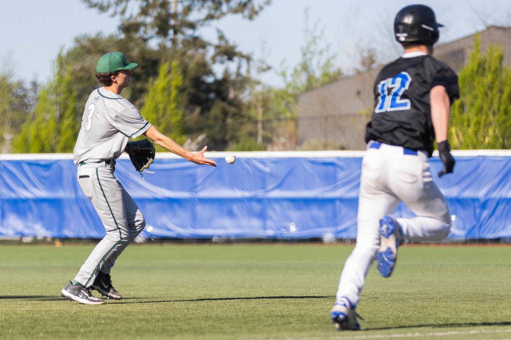 Edmonds-Woodways Finn Crawford tosses the ball to first base during the game against Shorewood on Wednesday, April 29, 2026 in Shoreline, Washington. (Olivia Vanni / The Herald)