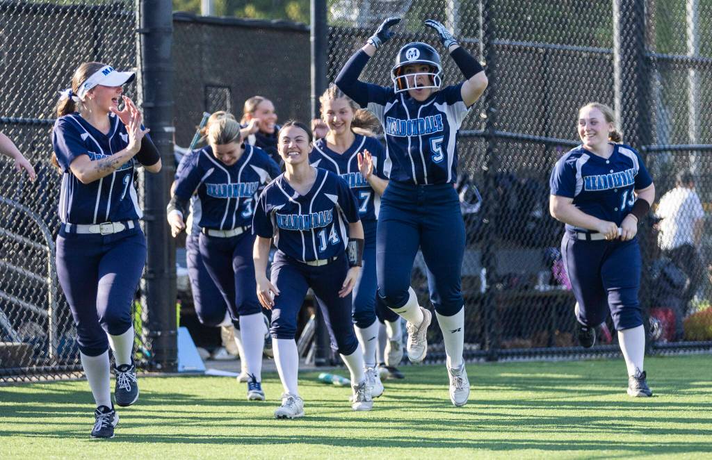 Meadowdale players react after Meadowdales Lillian McCormick hits a home run during the game against Shorewood on Thursday, April 30, 2026 in Lynnwood, Washington. (Olivia Vanni / The Herald)