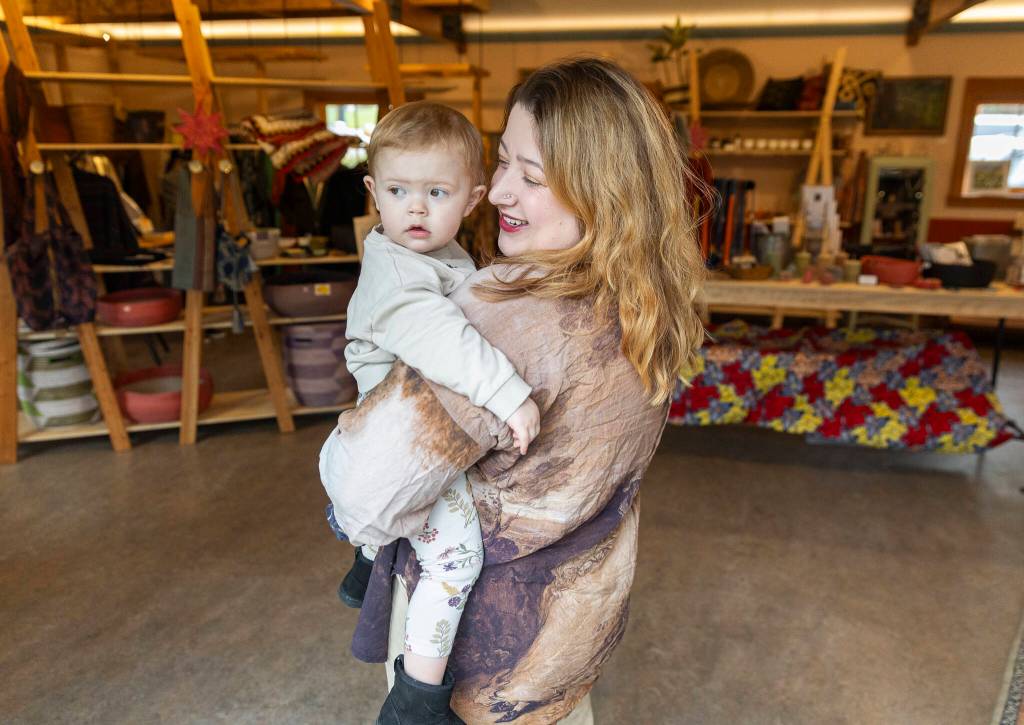 Francesca Coenen-Winer, owner of the Old Soul Bazaar and Bayview Corner Taproom inside the Old Soul Bazaar with her daughter on March 12, 2026 in Langley. (Olivia Vanni / The Herald)
