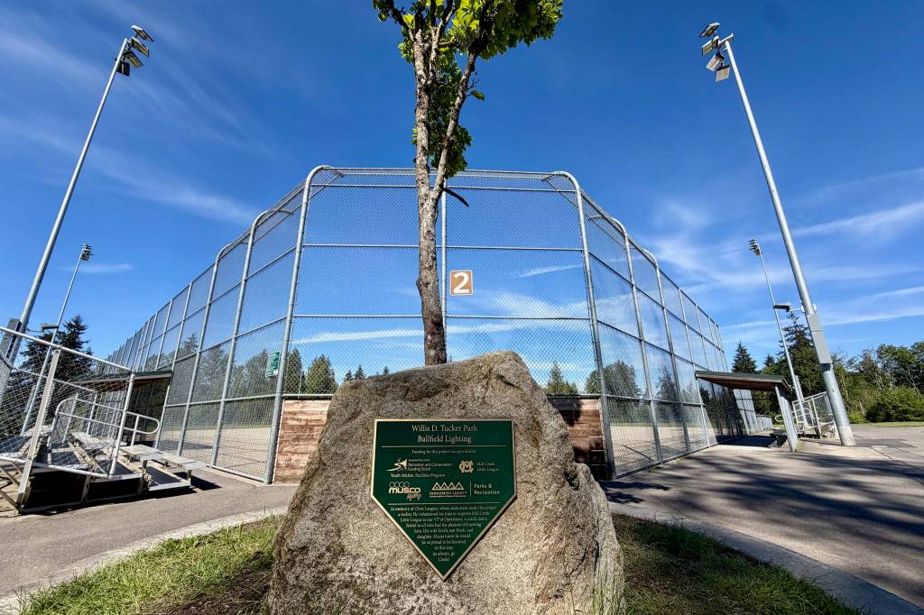 A plaque recognizes the contributions of Chris Langsea to Mill Creek Little League, including the leading of lights being installed at Field 2 at Willis Tucker Park in Snohomish, Washington. (Aaron Coe / The Herald)