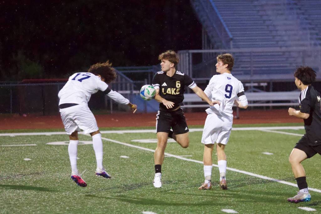 Glacier Peak senior Joziah Coppin (left) heads the ball into Lake Stevens junior Mac Wilson during the Grizzlies 3-1 loss to the Vikings at Lake Stevens High School on May 1, 2026. (Joe Pohoryles / The Herald)