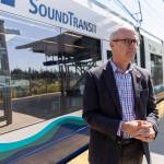A SoundTransit Link train pulls into the Mountlake Terrace station as U.S. Representative Rick Larsen talks about the T&I Committee’s work on the surface reauthorization bill on Wednesday, April 16, 2025 in Mountlake Terrace, Washington. (Olivia Vanni / The Herald)