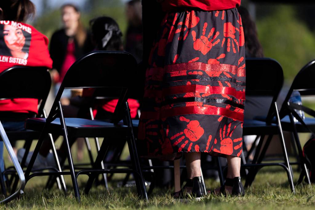 A ribbon skirt covered in red handprints is illuminated by the sun during a rally honoring missing and murdered Indigenous people on Tuesday, May 5, 2026, in Tulalip, Washington. (Olivia Vanni / The Herald)