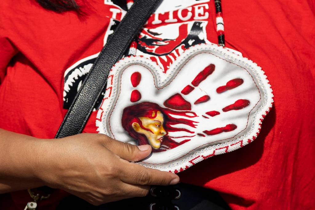 An MMIW beaded pendant necklace hangs around the neck of a rally attendee in honor of missing and murdered Indigenous people on Tuesday, May 5, 2026, in Tulalip, Washington. (Olivia Vanni / The Herald)
