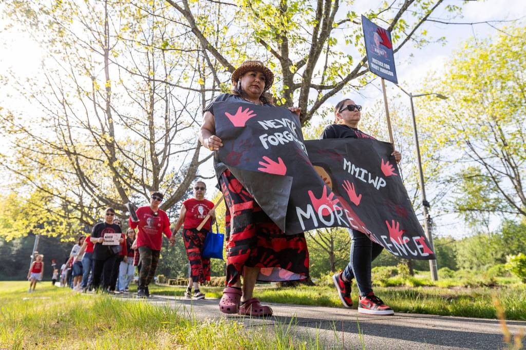 Cynthia Leon-Ortiz and Shawnee Sheldon walk with a banner during a march in honor of missing and murdered Indigenous people on Tuesday, May 5, 2026, in Tulalip, Washington. (Olivia Vanni / The Herald)