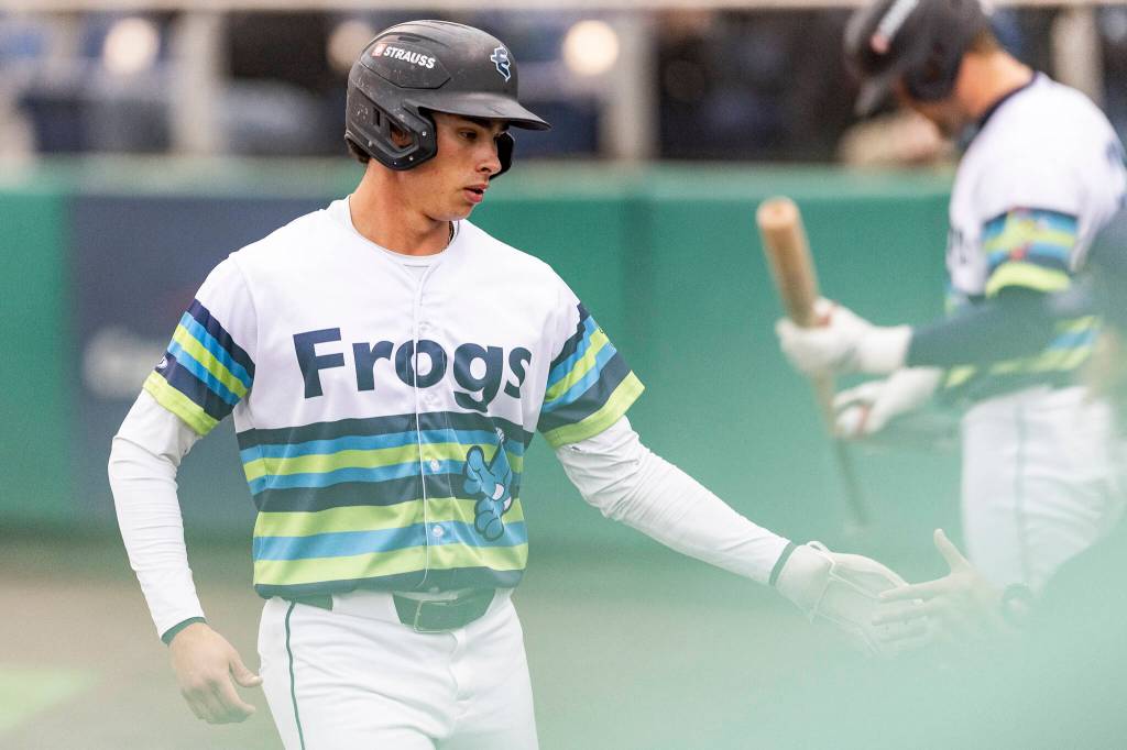 Jonny Farmelo #15 of the Everett AquaSox high-fives a teammate after scoring during the game against the Hillsboro Hops on Wednesday, May 6, 2026 in Everett, Washington. (Olivia Vanni / The Herald)