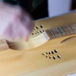Beverly Hoback plays a song on a dulcimer on Thursday, May 7, 2026 in Arlington, Washington. (Olivia Vanni / The Herald)