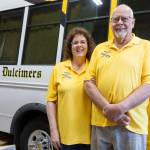 Teresa Ellis and John Ellis next to their Sunny Days Dulcimers van they bring with them to festivals on Thursday, May 7, 2026 in Arlington, Washington. (Olivia Vanni / The Herald)