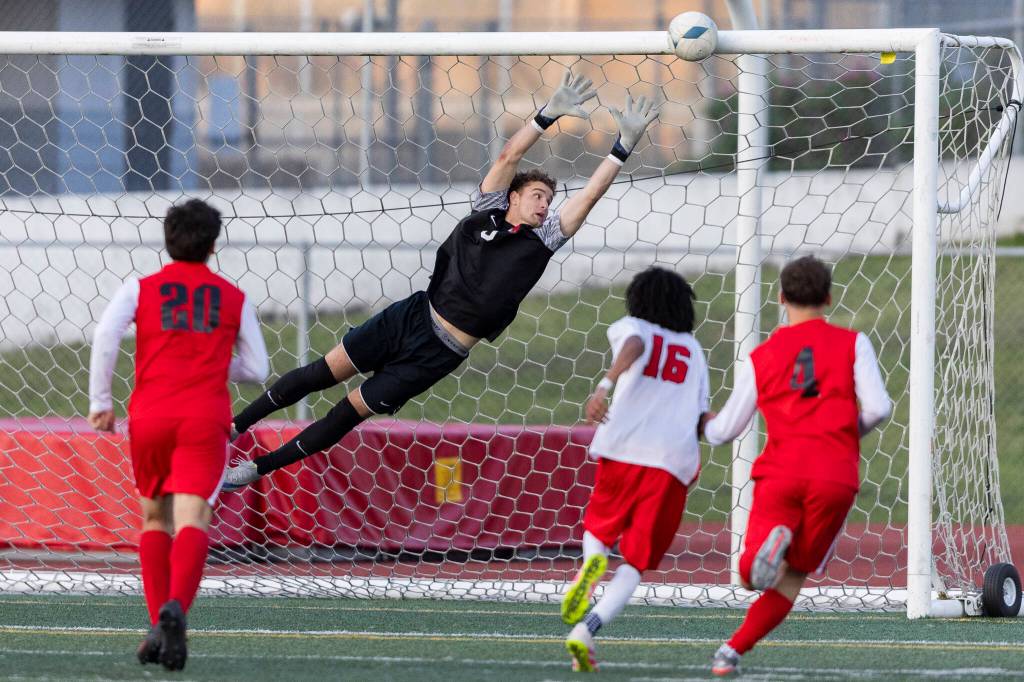 Snohomishs Zachary Khorrami dives for a shot by Mountlake Terraces Ash Jeffers as the ball hits off the cross bar during the second half of the loser-out 3A district playoff game on Thursday, May 7, 2026 in Snohomish, Washington. (Olivia Vanni / The Herald)