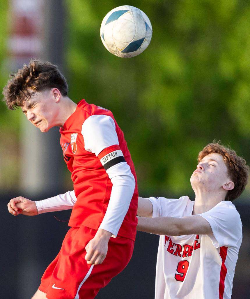 Mountlake Terraces Nathan Anderberg pushes Snohomishs Carson Maechler as he jumps up to head the ball during the loser-out 3A district playoff game on Thursday, May 7, 2026 in Snohomish, Washington. (Olivia Vanni / The Herald)