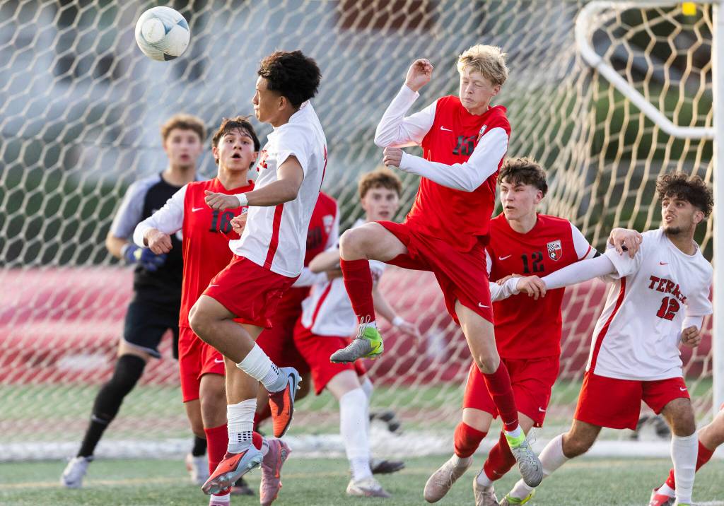 Mountlake Terraces Tien Tieu and Snohomishs Mitch Mitchell jump to head a corner kick during the loser-out 3A district playoff game on Thursday, May 7, 2026 in Snohomish, Washington. (Olivia Vanni / The Herald)