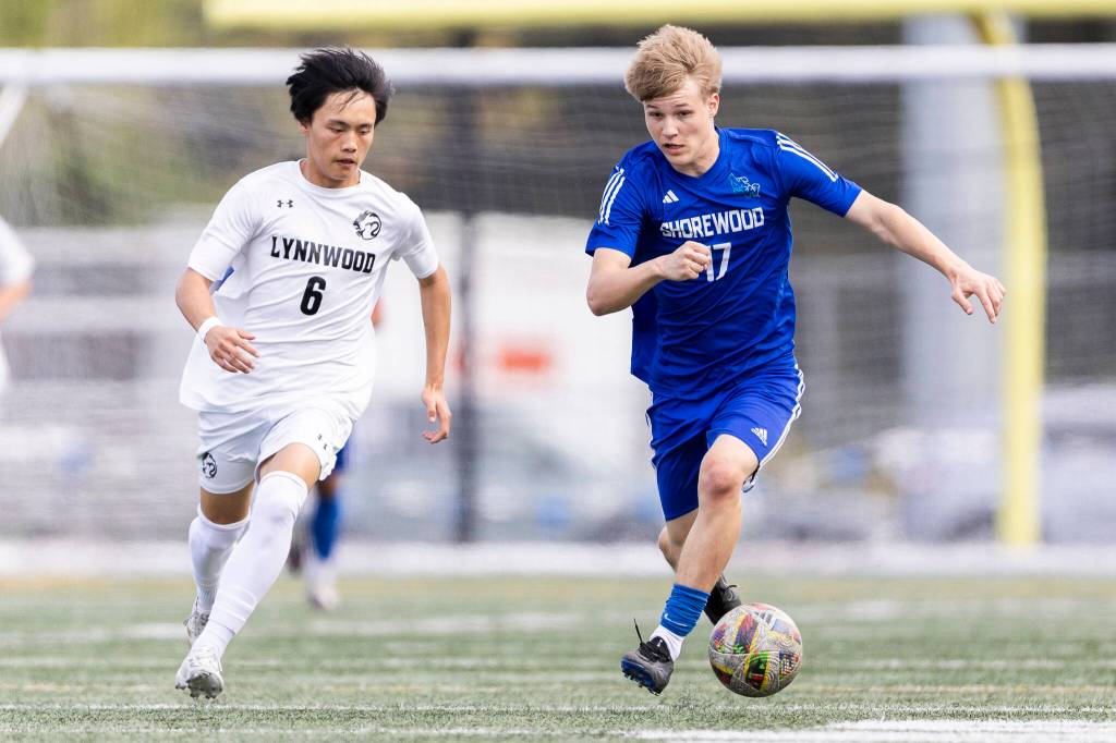 Shorewoods Julian Shook takes the ball up the field while under pressure from Lynnwoods Kai OBrien during the 3A district semifinal game on Tuesday, May 12, 2026 in Shoreline, Washington. (Olivia Vanni / The Herald)