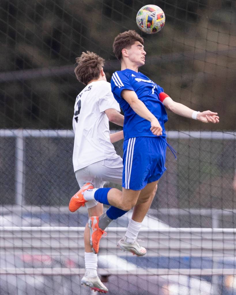 Lynnwoods Vladyslav Tarasiuk and Shorewoods Daniel Bruno jump up to head the ball during the 3A district semifinal game on Tuesday, May 12, 2026 in Shoreline, Washington. (Olivia Vanni / The Herald)