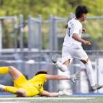 Lynnwoods Henrry Torres-Hernandez jumps over Shorewoods Maxwell Smith during the 3A district semifinal game on Tuesday, May 12, 2026 in Shoreline, Washington. (Olivia Vanni / The Herald)