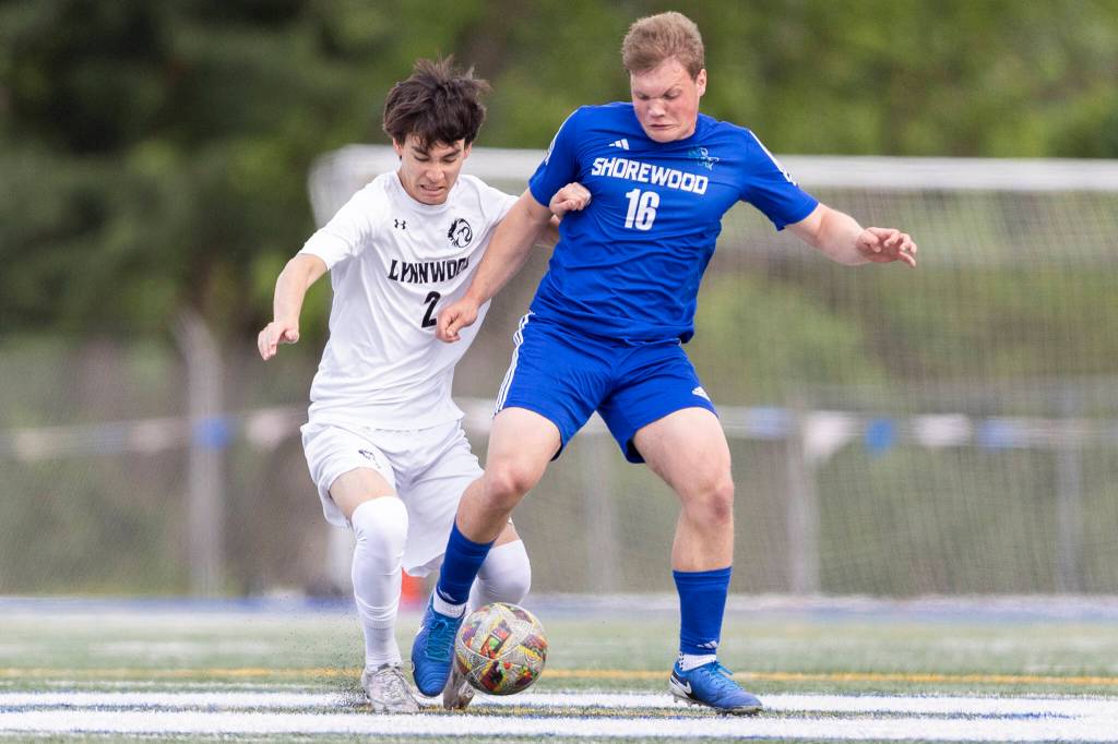 Shorewoods Caleb Butler and Lynnwoods Samson Ilano battle for the ball during the 3A district semifinal game on Tuesday, May 12, 2026 in Shoreline, Washington. (Olivia Vanni / The Herald)