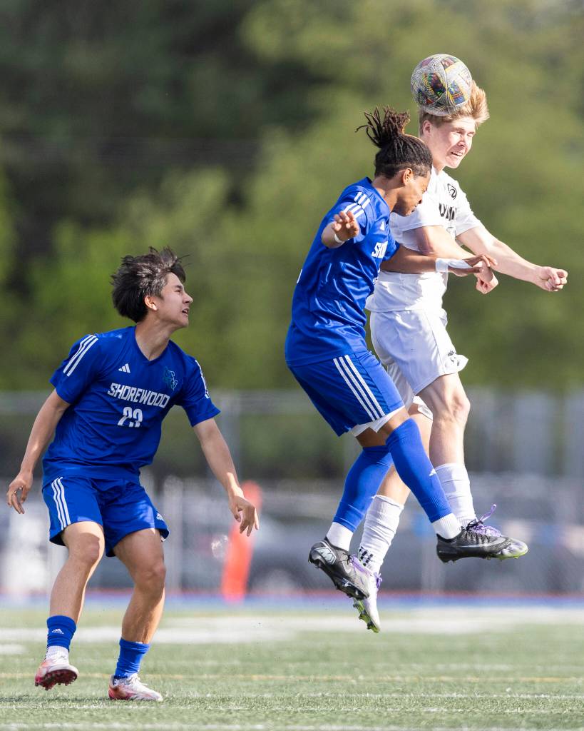 Shorewoods Meiron Bereket and Lynnwoods Brandon Miller jump up to head the ball during the 3A district semifinal game on Tuesday, May 12, 2026 in Shoreline, Washington. (Olivia Vanni / The Herald)